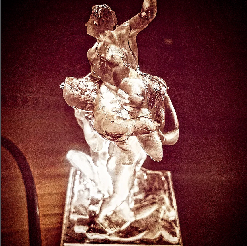 Demonstration resin print of a dramatic multi-figure sculptural composition.